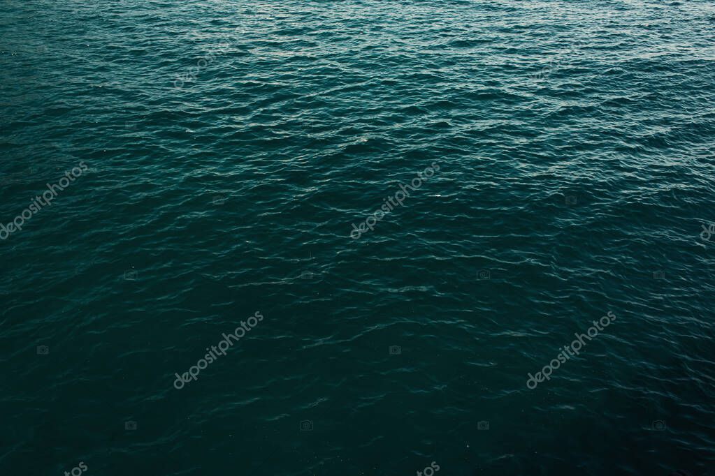 Calm water with gentle ripples reflecting soft light