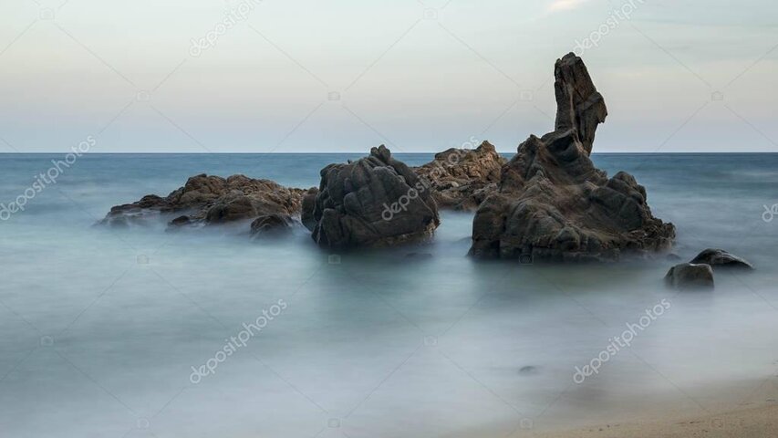 Soft water moving around coastal rocks in long exposure